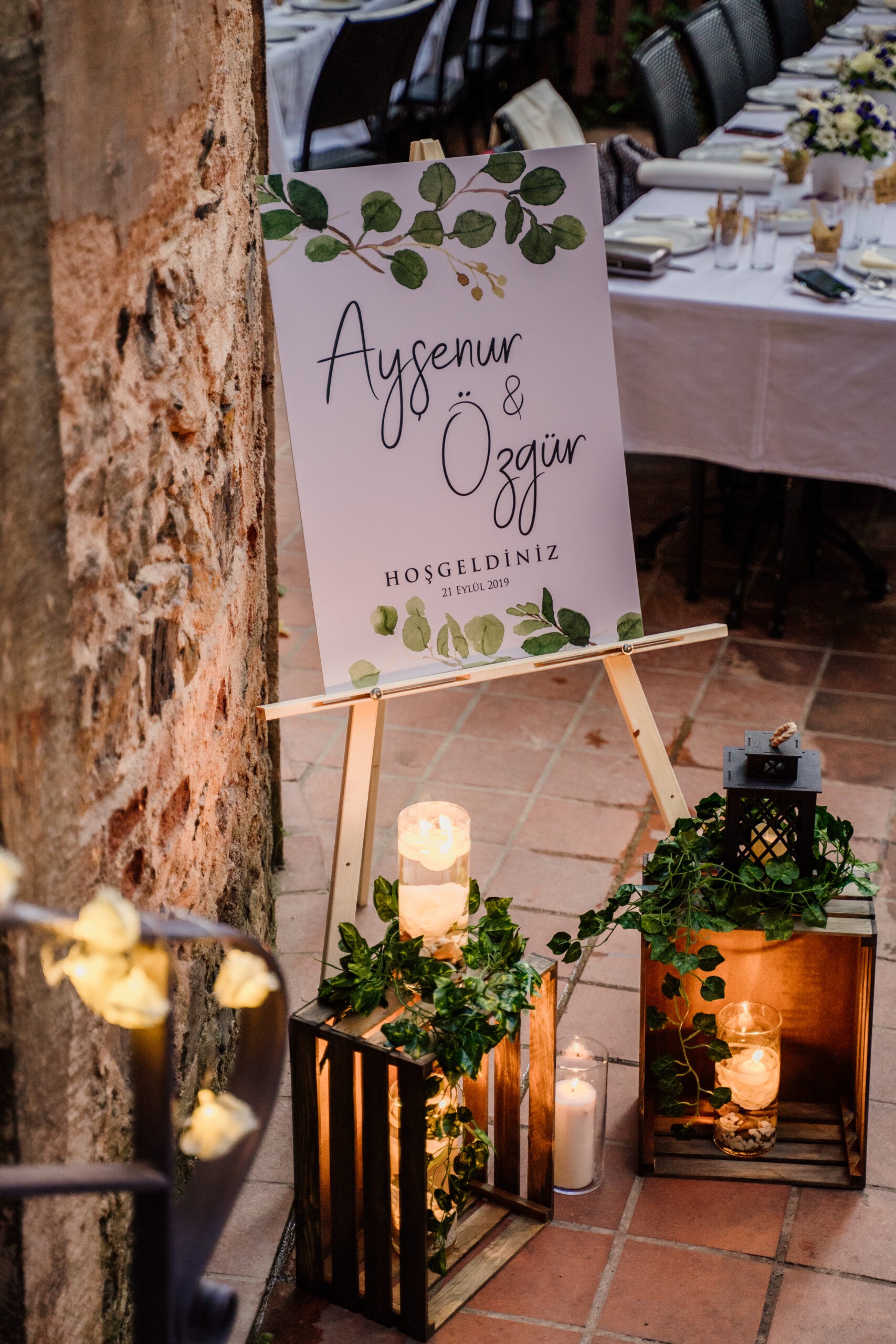 Welcome sign and lanterns at a wedding venue entrance